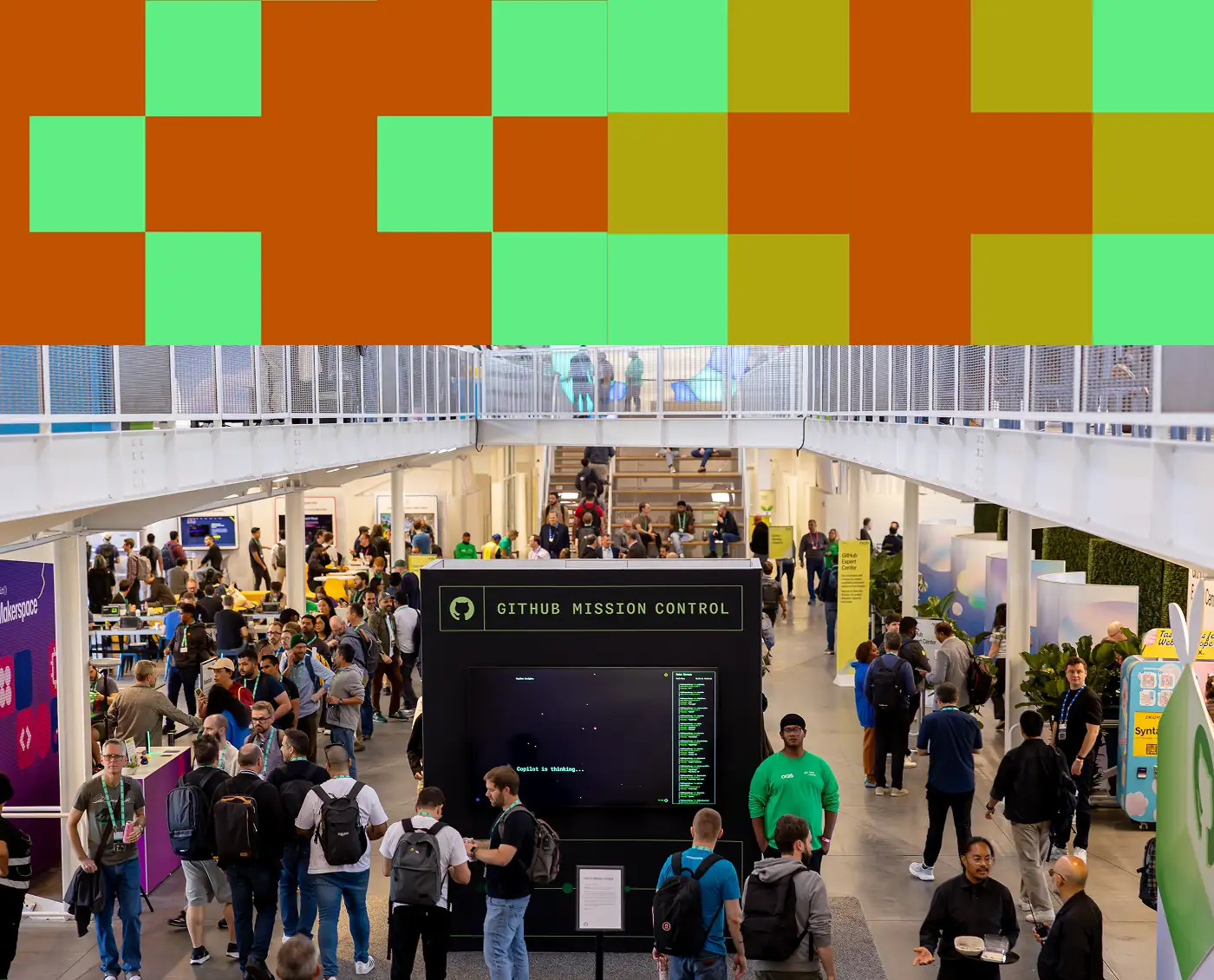 Attendees gather in a large GitHub Universe expo hall around a central GitHub Mission Control display.